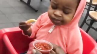 This girl will make you laugh after trying the ketchup with French fries for the first time