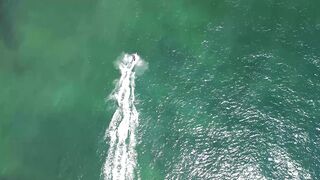 Top view of a motor boat sailing in the blue calm waters of the sea on a sunny day