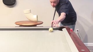 An unrealistic billiard trick