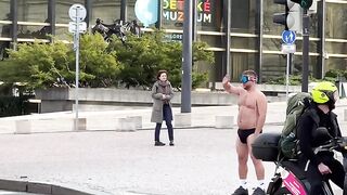 Guy is walking through an intersection in his underwear while playing a VR game