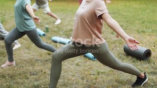 Elderly People Having Outdoor Yoga Workout with Female Instructor