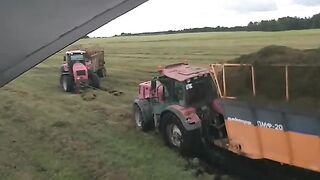 A trailer with grass overturned on the field