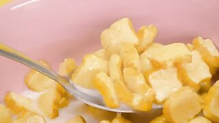 Taking cereal with milk from a bowl with a spoon