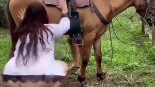 Two beautiful  playing with a horse