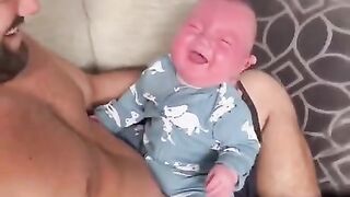 A baby laughing hard with dad ????????