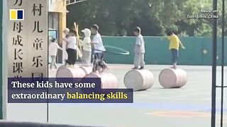 Children practise tricks while walking on cylinder in kindergarten