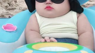 Cute and funny baby on the beach