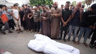 Palestinians mourn 3 civil defense workers killed in Israeli airstrike in central Gaza