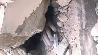 A Palestinian man asked for help after being trapped under the rubble following