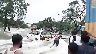 The car is not able to stand well in the flood of water.