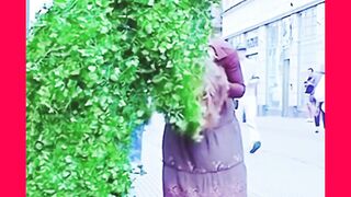 A person disguised in wreaths of marsh, which surprises passersby