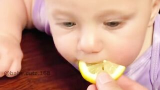 Baby eats lemon for the first time