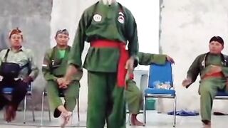 an old man demonstrating pencak silat moves