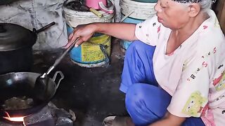 Cooking the traditional way with firewood in a house in the middle of a rice field