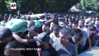 Funerals held for 18 Palestinians killed by Israeli strike in West Bank.