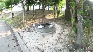 A round-faced cat sleeps sleepily on the manhole cover.