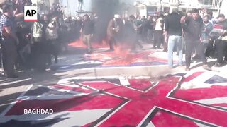 Iraq residents burn flags as they protest against the US, UK and Israel.