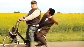 Mr. Bean rides a motorcycle with his friend and ends up causing it to break down.