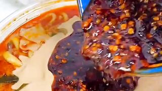 Eating sticky spicy Malatang hotpot with sesame paste and chili oil