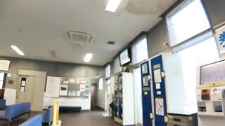 A calico cat rests on a locker in the ferry waiting room, and comes down to be mopped when someone comes.