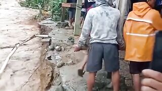 Villagers work together to move houses that will be affected by flooding