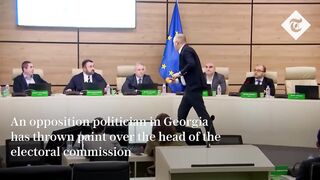 Shocking moment Georgian politician throws paint over election chief.