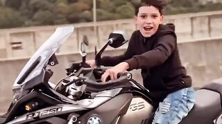 Little boy controls BMW motorcycle