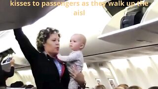 The adorable baby is seen blowing kisses to passengers as they walk up the aisl