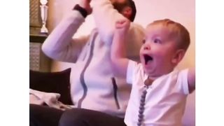 Son and Father watching match on TV