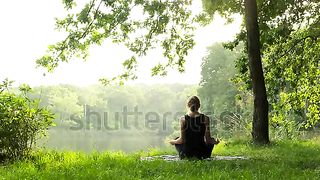 Woman meditating, zen yoga meditation practice in nature