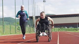 A female person with disabilities riding a wheelchair